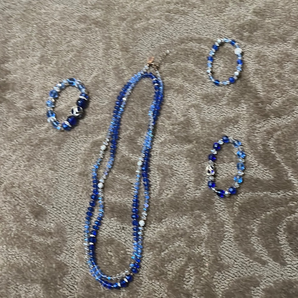 3 bracelets and a necklace.